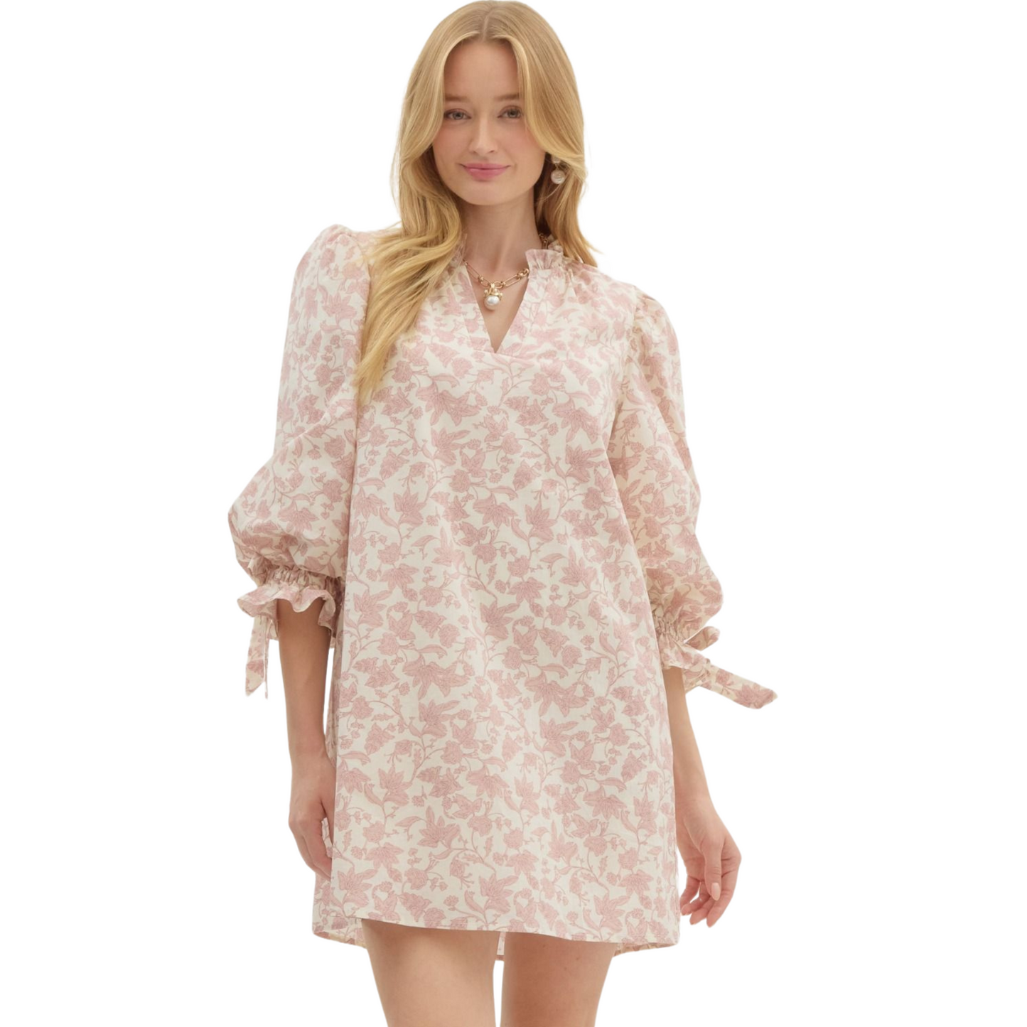 Introducing our Floral Print Pullover Mini Dress with ¾ puff sleeves and fixed ribbon detailing. Stay stylish and functional with side pockets, inner lining, and non-sheer, lightweight fabric. In a lovely rose color, this dress is perfect for any occasion.