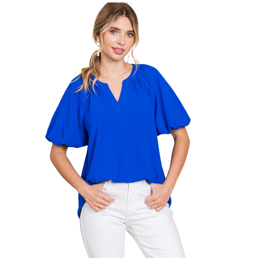 This royal blue v-neck top features lightweight fabric and trendy balloon sleeves, perfect for adding a touch of style to any outfit. The v-neck design is flattering and the balloon sleeves add a unique element to this versatile top. Elevate your wardrobe with this must-have piece.