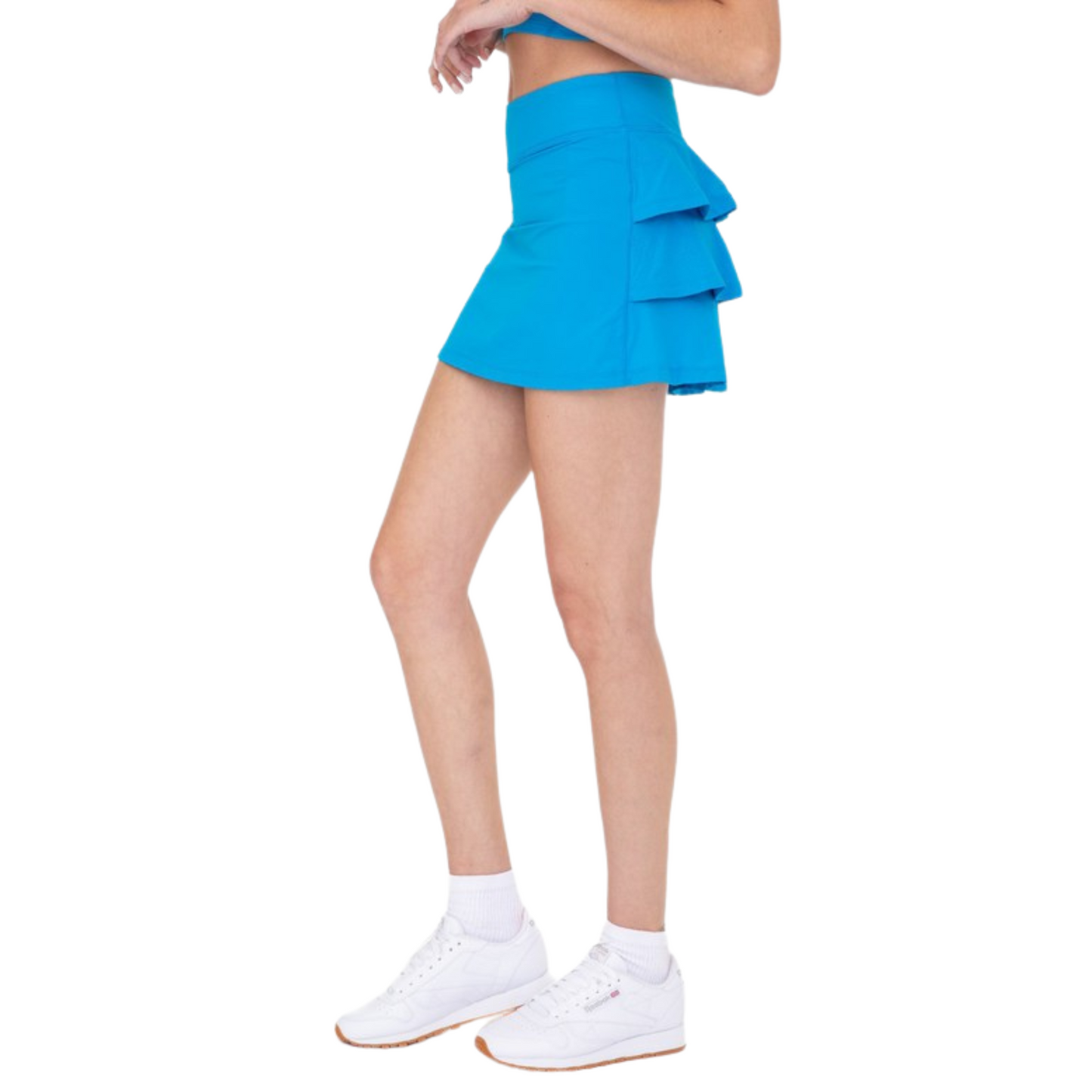 This flirty active skort has a sleek front, built-in shorts, and micro-perforated ruffles in the back for added breathability.