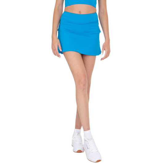 This flirty active skort has a sleek front, built-in shorts, and micro-perforated ruffles in the back for added breathability.