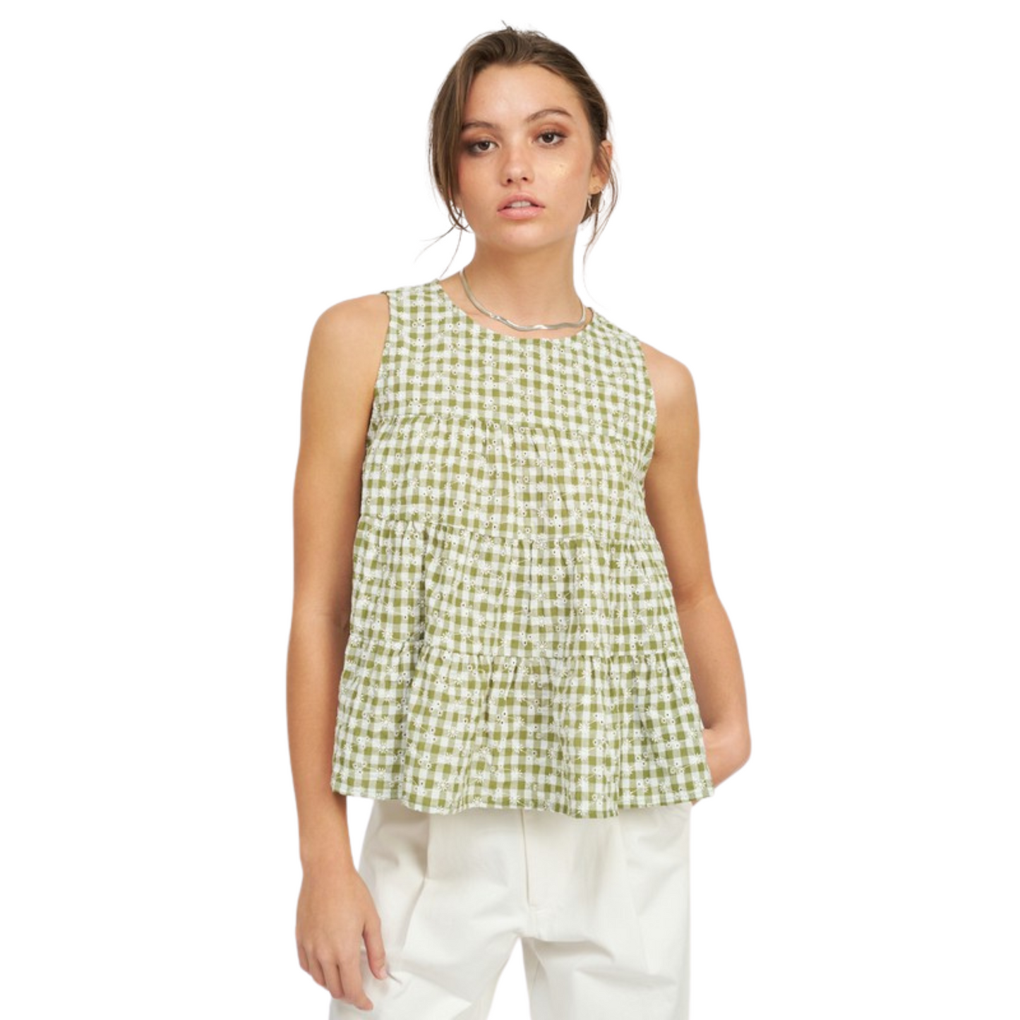 This Ruffled Sleeveless Top is made with lightweight fabric featuring a classic gingham pattern in green and white. Its sleeveless design and beautiful ruffles make it ideal for warm summer days.