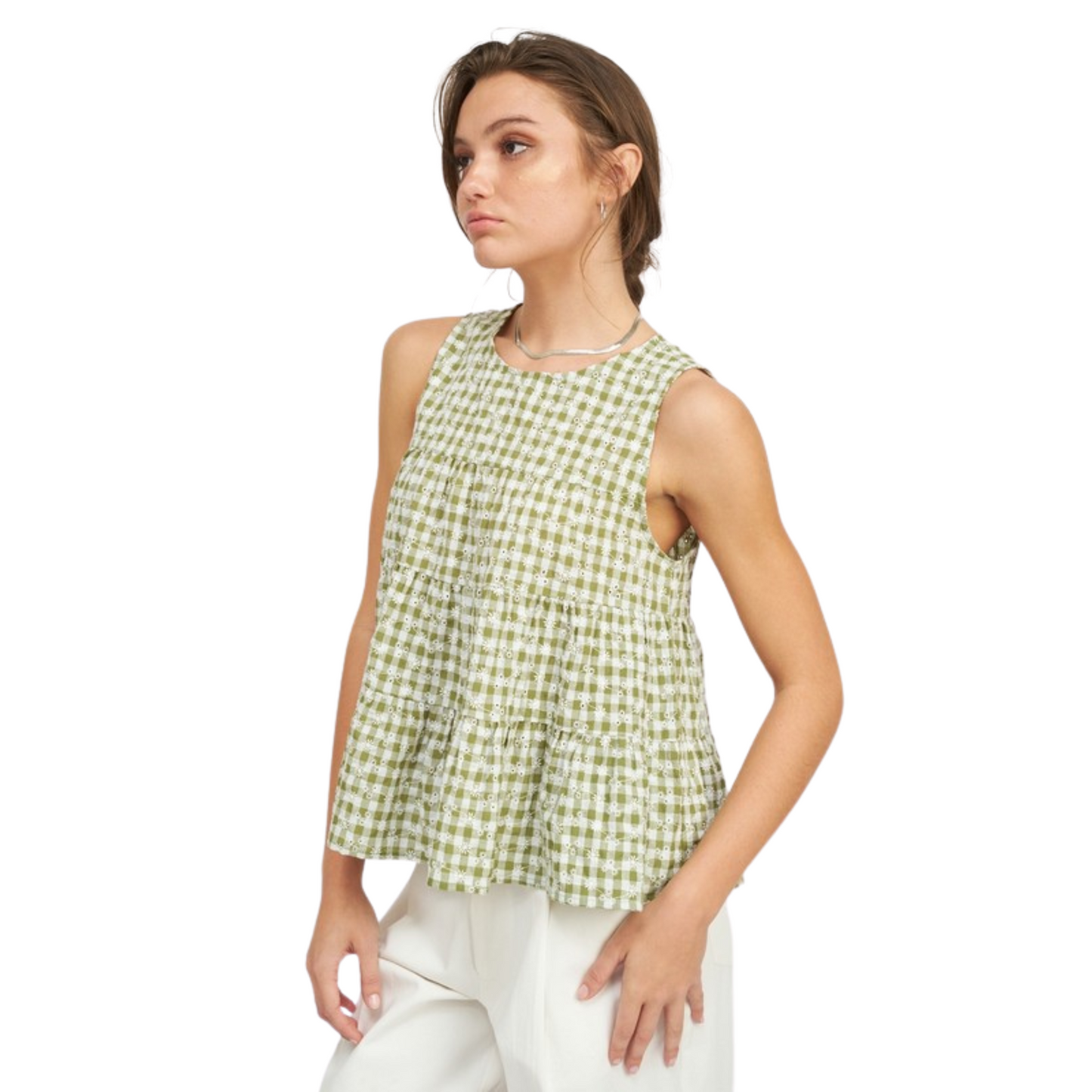 This Ruffled Sleeveless Top is made with lightweight fabric featuring a classic gingham pattern in green and white. Its sleeveless design and beautiful ruffles make it ideal for warm summer days.