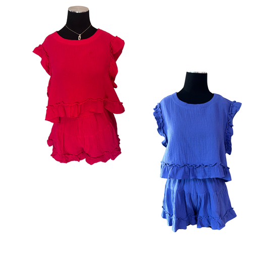 Elevate your casual wardrobe with this charming two-piece set. The cropped top features delicate ruffle sleeves that add a playful touch, while the coordinating shorts complete the look. Crafted in a vibrant blue, this set is perfect for warm weather outings, weekend brunches, or relaxed gatherings. The fitted silhouette flatters your figure while the ruffled details bring movement and style. Mix and match with your favorite accessories for endless outfit possibilities.