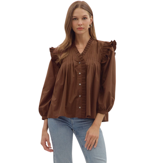 This brown 3/4 sleeve top from Entro features elegant pleated shoulder ruffle details, adding a refined touch to your wardrobe. Its tailored fit and sophisticated design make it ideal for professional settings or stylish casual wear. The 3/4 sleeves provide comfortable coverage while maintaining a polished look.