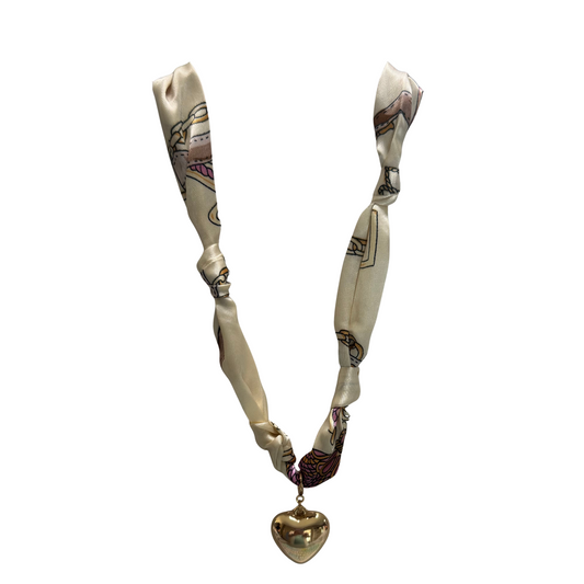 Elevate your accessory collection with the Golden Stella Scarf Necklace and Earring Set. Featuring a delicate gold heart charm, this set combines the elegance of a soft scarf necklace with matching earrings for a cohesive, sophisticated look. Perfect for adding a refined touch to both casual and formal outfits, this expertly crafted set offers versatility and timeless style.