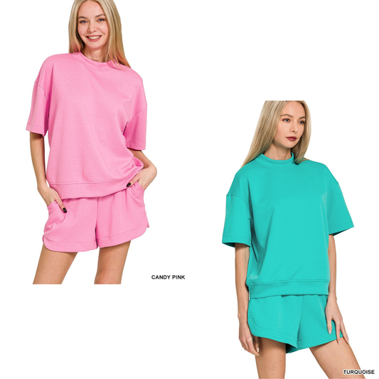 Update your casual wardrobe with this Zenana scuba high neck top and shorts set. The soft, stretchy fabric offers comfort and a flattering fit, while the high neckline provides modern style. Short sleeves keep you cool and versatile for any season. Available in candy pink or turquoise, this coordinated set makes getting dressed effortless. Perfect for lounging, running errands, or casual outings.