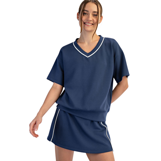 Modal Scuba Top and Skort Set in navy and cream delivers effortless style and comfort. The soft modal fabric drapes beautifully while providing breathability for all-day wear. The coordinated two-piece design pairs a fitted scuba top with a flattering skort, creating a polished look perfect for casual outings or active days. The navy and cream color combination offers versatile styling options that work with your existing wardrobe.