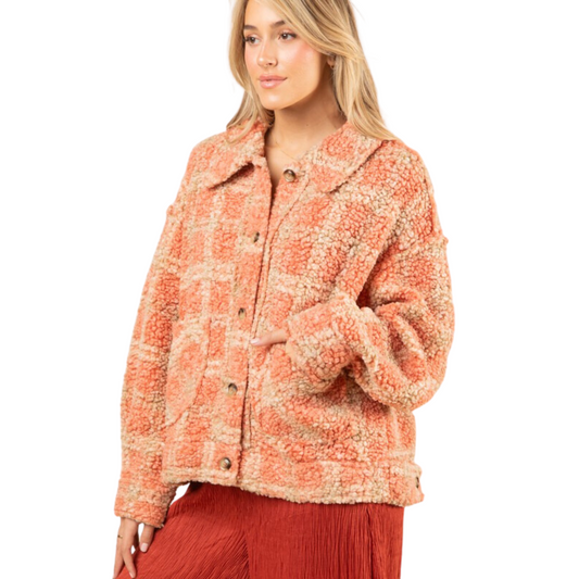 This oversized plaid shacket is perfect for combining comfort and style. It features a drop shoulder design with long sleeves, and is button-up with front pockets. The cozy sherpa material adds warmth, making this shacket a great choice for the winter months.