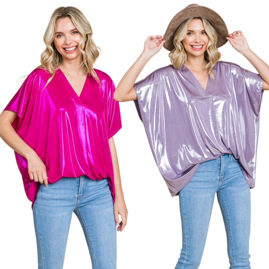 <p>Add effortless glamour to any look with our Shiny Solid V-Neck Boxy Top. Available in both fuchsia and violet, this lightweight and flowy design features a v-neck neckline and short sleeves for an effortlessly stylish finish. The shimmery fabric is perfect for day or night.</p> <p>&nbsp;</p>