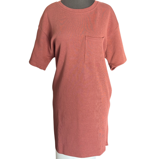 This Short Sleeve Knit Mini Dress from She + Sky combines cozy heavy-knit fabric with a chic, cinnamon color for stylish warmth. Designed with practical side pockets, it offers convenience without sacrificing form. Its short sleeves and mini length create a balanced silhouette perfect for transitional weather or layering, making it a versatile addition to your wardrobe.