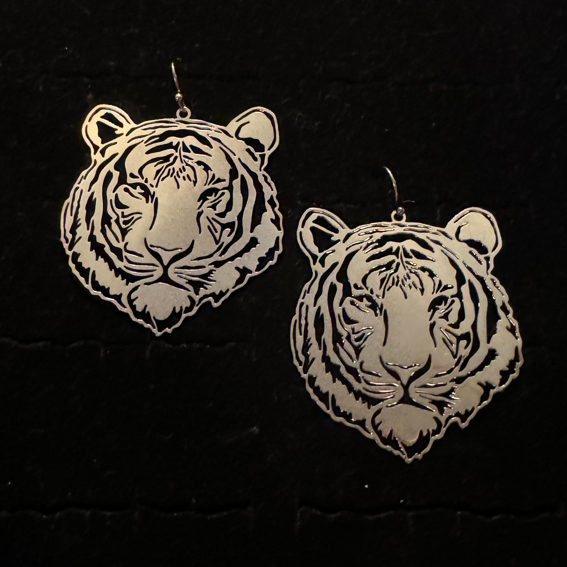 These Tiger Filigree Earrings boast an elegant worn gold finish, featuring intricate filigree detailing. Crafted in a stylish tiger shape, these dangle earrings are the perfect accessory for any fashionable outfit. Add a touch of sophistication and wild flair to your look.