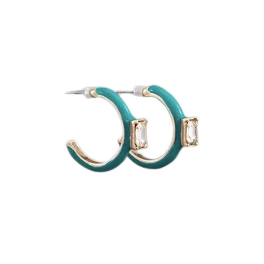 Our single gem colored hoops bring unique, eye-catching style to any look. Crafted from gold plated metal, their teal color and delicate rhinestone accents give them an elegant finish. Perfect for adding a subtle hint of sophistication or a pop of color, these small hoops will quickly become your favorite go-to accessory.