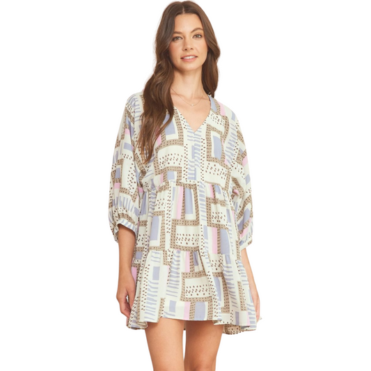 This printed v-neck mini dress is a versatile addition to your wardrobe. The 3/4 sleeves and button closure at the back make it easy to style for any occasion. With pockets at the side, you can keep your essentials close by. The semi-sheer fabric is lightweight and lined for comfort. Available in a beautiful slate blue color.