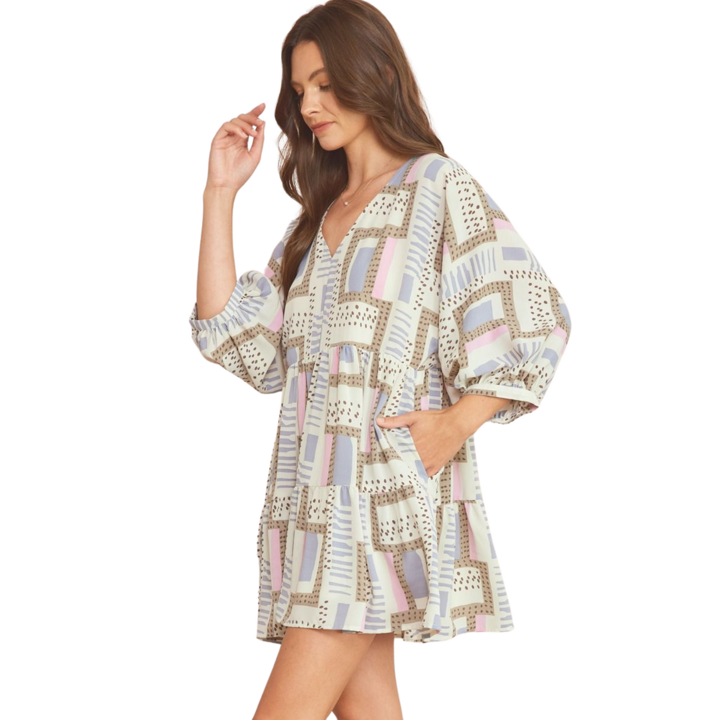 This printed v-neck mini dress is a versatile addition to your wardrobe. The 3/4 sleeves and button closure at the back make it easy to style for any occasion. With pockets at the side, you can keep your essentials close by. The semi-sheer fabric is lightweight and lined for comfort. Available in a beautiful slate blue color.