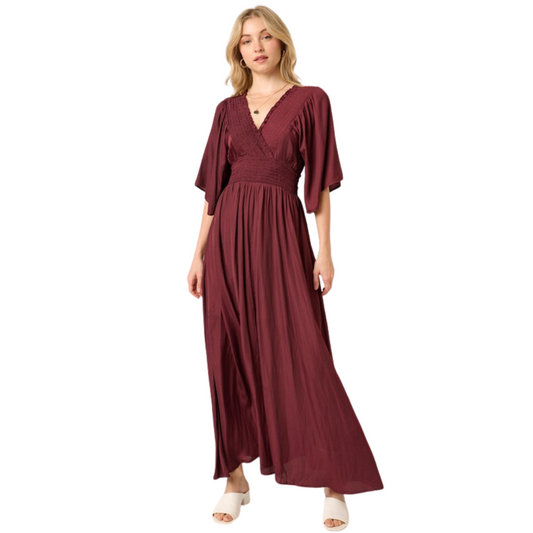 The Smock Detail Maxi Dress is made with luxurious satin woven fabric for a smooth and sophisticated look. Featuring smocking detail on the front and back, a surplice front, ruffle short sleeve and smocking detail waistband, this dress ensures a comfortable and flattering fit. Finished with a maxi length silhouette, this beautiful wine-colored dress is perfect for any special occasion.