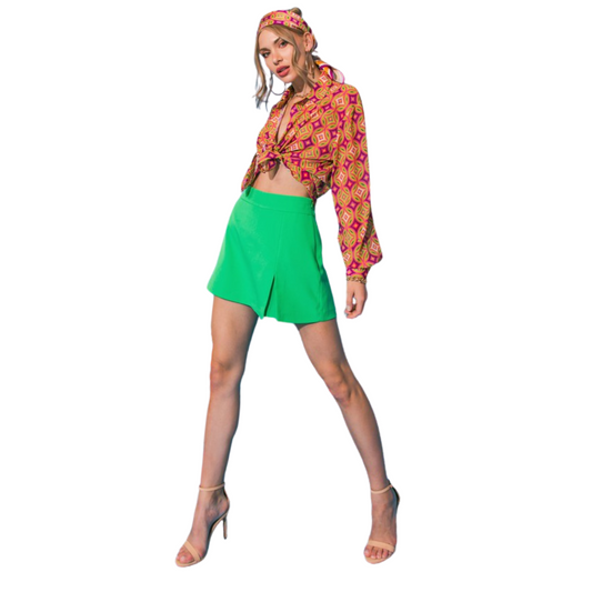 Enjoy the classic look of a skirt with the comfort and convenience of shorts in the Solid Woven Skort from Flying Tomato. This skort features a front slit and side zipper for superior comfortability, and the timeless green color will look great in any wardrobe. Perfect for any casual look or for hitting the links.