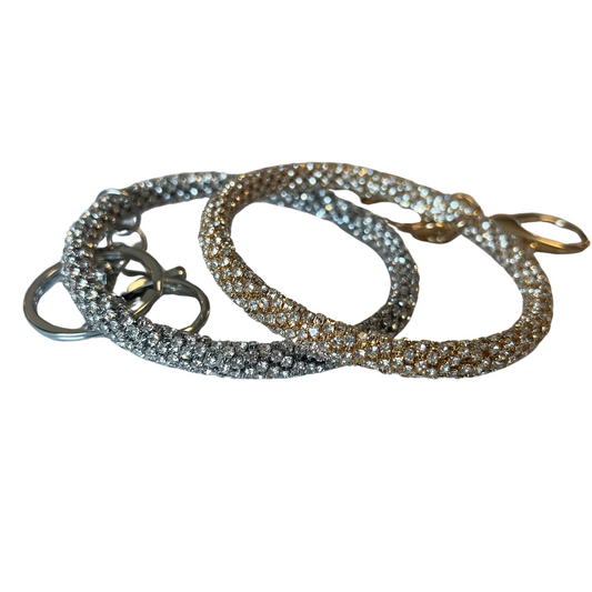 The Sparkle Bangle Keychain is a fashionable accessory to any set of keys. Crafted from durable materials, it comes in two colors including silver and gold, both decorated with sparkling rhinestones for added glamour. Carry your keys in style with this stunning keychain.