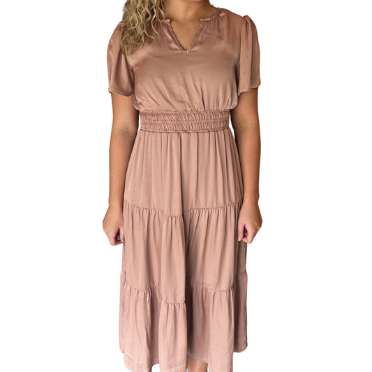 This Split Neck Tiered Dress is the perfect addition to your wardrobe. Crafted with a dusty blush color, featuring a deep v neck and long sleeves, this midi dress is a timeless style for any occasion. Wear it casually with trainers or dress it up with strappy heels.