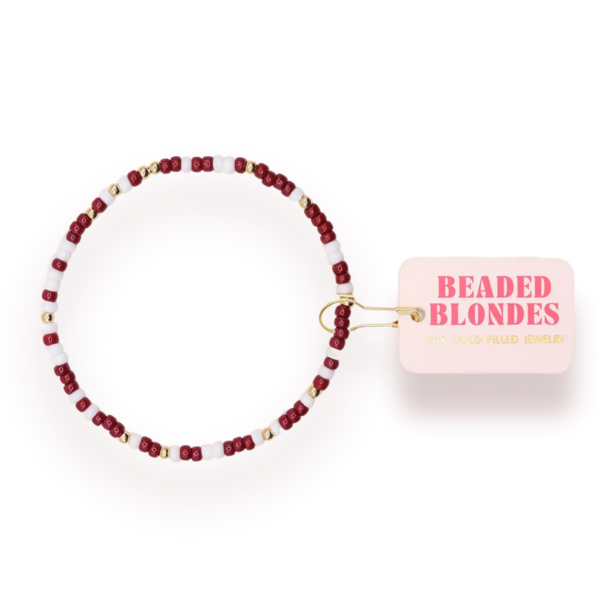 Introducing the Maroon and White Sprinkle, a stunning beaded bracelet from Beaded Blondes. This piece is perfect for everyday wear, hand-strung in College Station, Texas. It showcases the meticulous attention to detail and high quality that the brand is known for. Its 14K gold-filled and sterling silver beads are waterproof, workout proof, and tarnish proof, ensuring lasting beauty. This versatile piece brings a touch of class to any occasion.