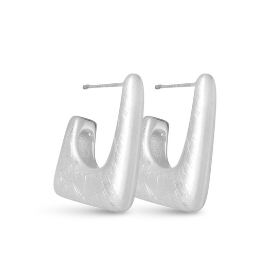 Experience effortless elegance with our Ava Square Huggie Hoops. Crafted from high-quality silver, these hoop earrings feature a sleek matte finish and unique square shape, making them the perfect accessory for any occasion. Elevate your style with these versatile and timeless hoops.