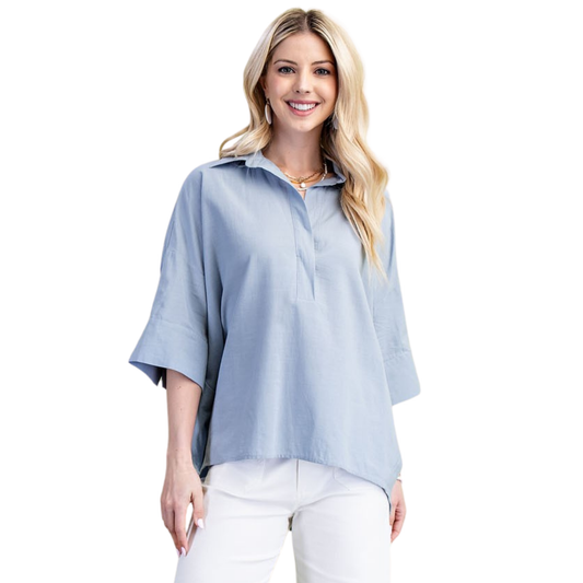 Lightweight V-Neck Popover Top in steel blue by GiGio. This versatile piece features a classic collared design with a flattering v-neckline and half sleeves, perfect for layering or wearing solo. The breathable fabric keeps you comfortable throughout the day, while the polished popover style transitions effortlessly from casual to professional settings. A wardrobe essential that pairs with everything.