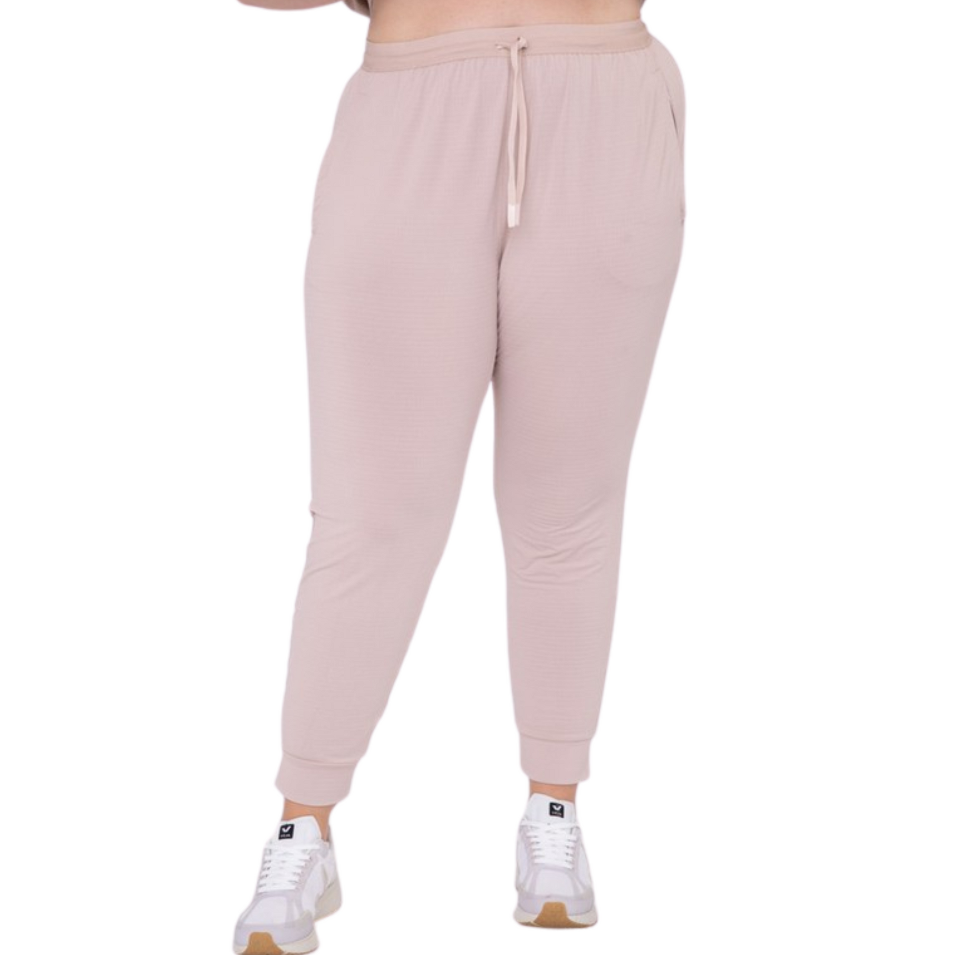 These joggers are made with a solid knit and textured interior, providing optimal airflow and comfort. The adjustable drawstring waistband and cuffed hems provide a custom fit, and the zipper pockets keep your essentials secure. Perfect for any active lifestyle, from jogging to lounging.