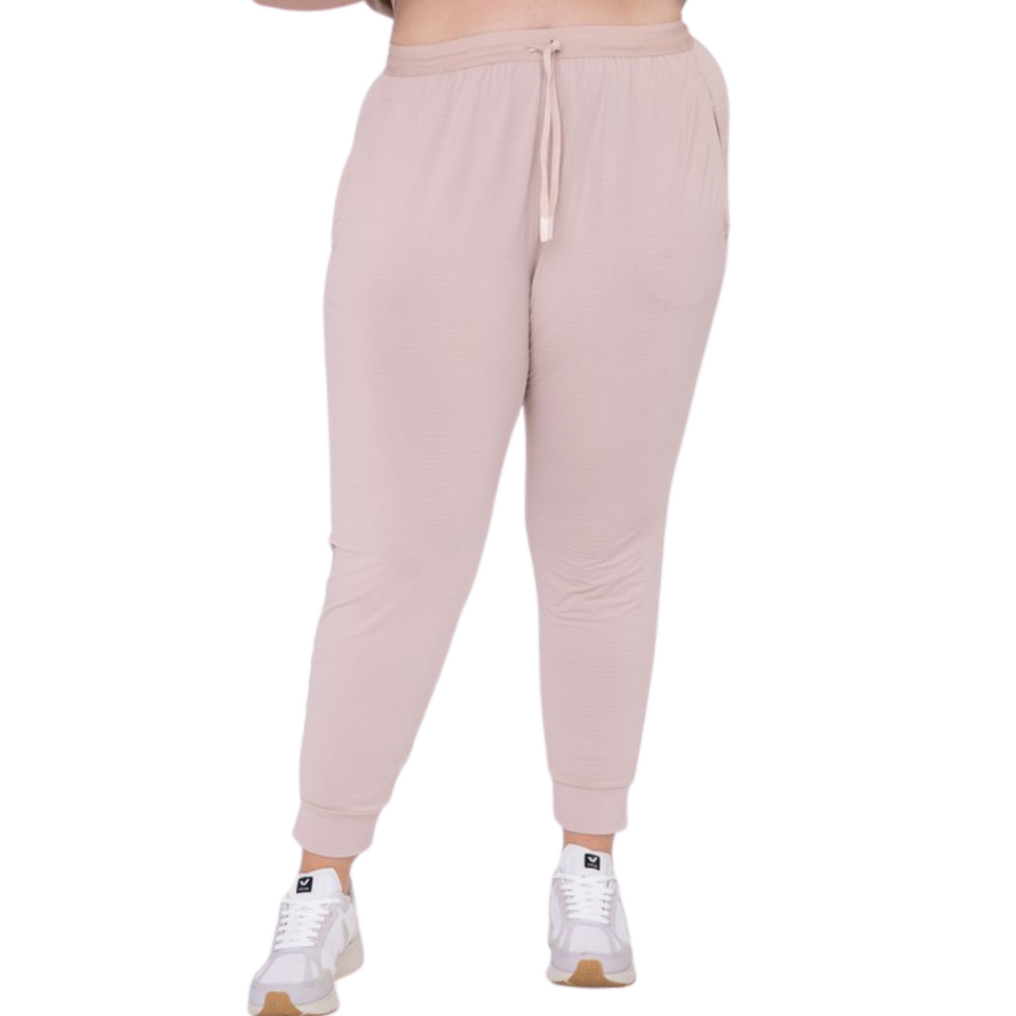 These joggers are made with a solid knit and textured interior, providing optimal airflow and comfort. The adjustable drawstring waistband and cuffed hems provide a custom fit, and the zipper pockets keep your essentials secure. Perfect for any active lifestyle, from jogging to lounging.