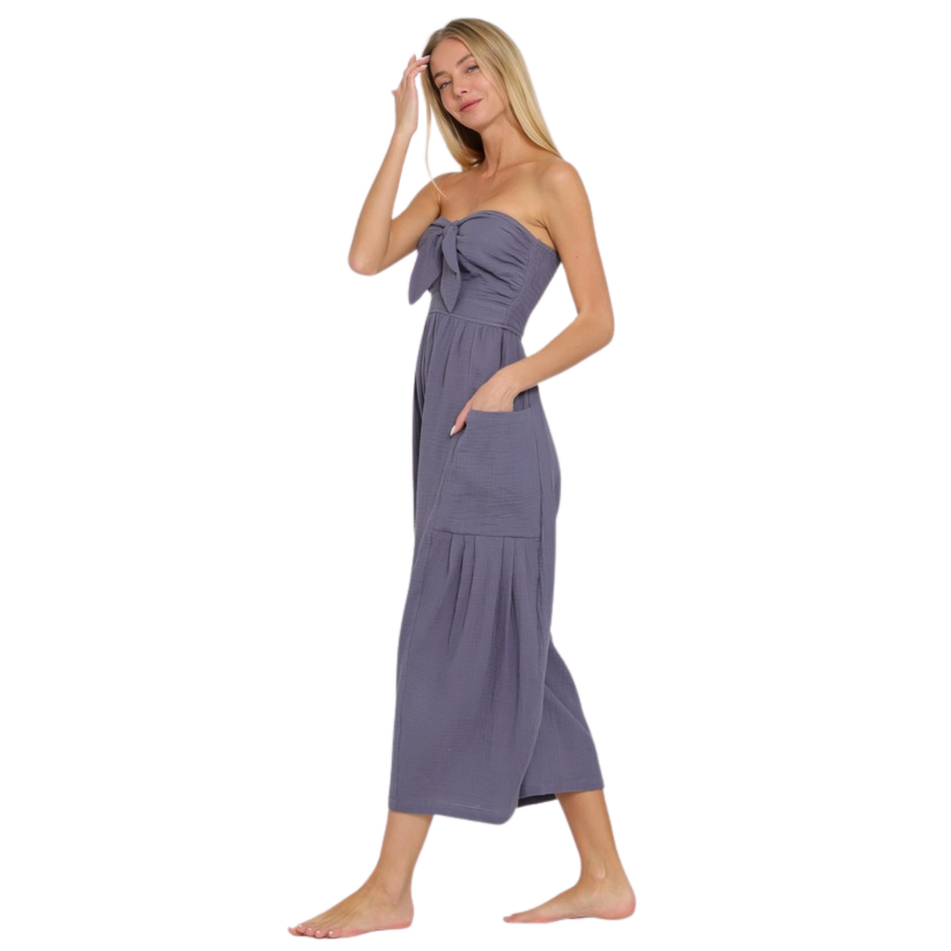 Introducing our Tube Smocked Jumpsuit in a stunning vintage blue color. This strapless jumpsuit features a flattering smocked design that accentuates your curves. With its ankle length and convenient pockets, this jumpsuit is both stylish and functional. Elevate your wardrobe with this must-have piece.