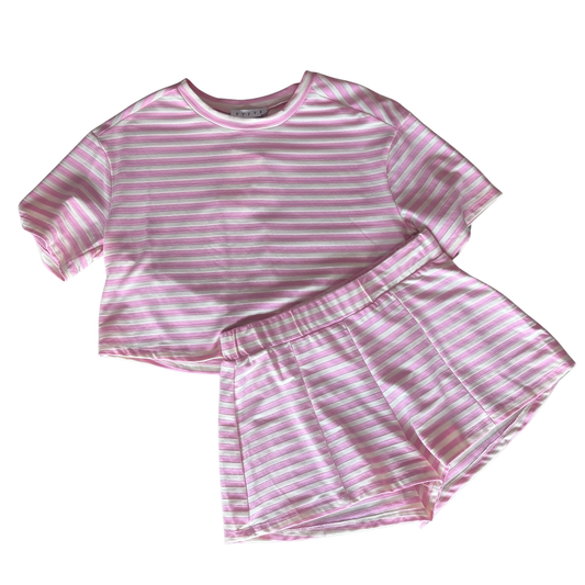 Elevate your casual wardrobe with this charming striped top and shorts set by HYFVE. The soft pink palette and classic striped pattern create a fresh, effortless look perfect for warm weather days. The short sleeve top pairs seamlessly with coordinating shorts for a put-together outfit straight from the package. Ideal for weekend outings, casual brunches, or relaxed everyday wear. Mix and match with your favorite accessories to create multiple styling options.