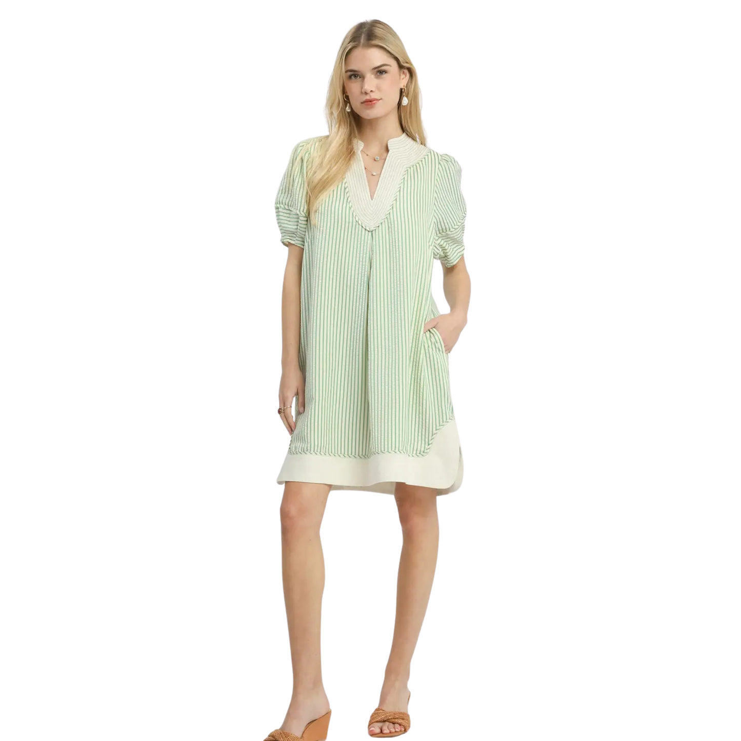 This Umgee striped mini dress combines effortless style with versatile appeal. The sage color palette pairs beautifully with neutral basics or bold accessories, while the classic V-neckline flatters various body types and works across seasons. Crisp stripes add visual interest without overwhelming, making this piece a reliable choice for casual outings, weekend gatherings, or layered styling. The mini length offers a modern silhouette that transitions seamlessly from day to evening wear.
