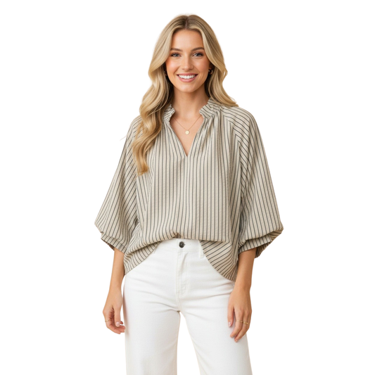 Effortless elegance meets comfort in this light sage striped blouse from Hemish USA. Designed for the modern woman, it features a flattering V-neck, three-quarter length sleeves, and a delicate scalloped hem that adds a touch of sophistication. The relaxed fit and quality construction make it perfect for layering or wearing solo. A versatile piece that transitions seamlessly from casual to polished looks.