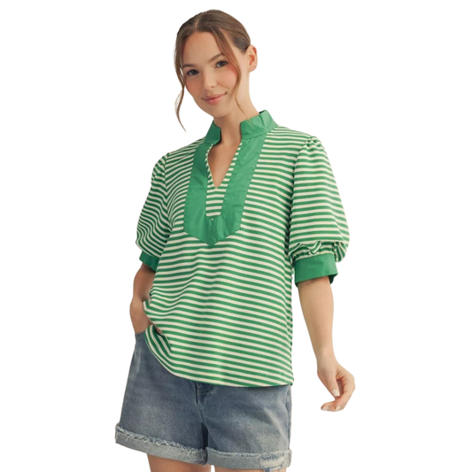 Elevate your wardrobe with this charming Jodifl puff sleeve top in rich kelley green. The flattering v-neckline and short puff sleeves create a feminine silhouette, while subtle striping adds visual interest and dimension. Perfect for layering or wearing solo, this versatile piece transitions seamlessly from casual days to evening outings. A timeless addition to any style-conscious closet.