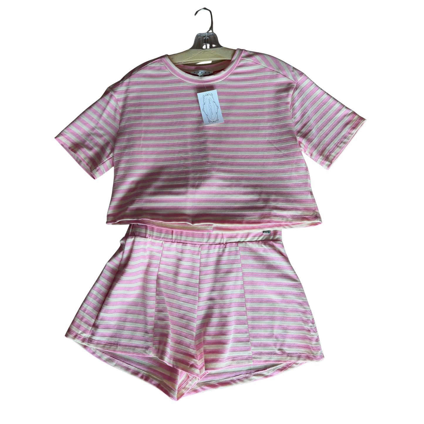 Elevate your casual wardrobe with this charming striped top and shorts set by HYFVE. The soft pink palette and classic striped pattern create a fresh, effortless look perfect for warm weather days. The short sleeve top pairs seamlessly with coordinating shorts for a put-together outfit straight from the package. Ideal for weekend outings, casual brunches, or relaxed everyday wear. Mix and match with your favorite accessories to create multiple styling options.