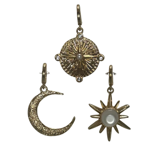 Elevate your scarf styling with this expert-curated set of three delicate charms featuring a sun, moon, and compass design. Crafted in gleaming gold with elegant pearl accents, these Golden Stella pieces add a refined touch to any accessory. Versatile and symbolic, they perfectly enhance scarves with sophisticated detail while reflecting timeless celestial and navigational inspiration.