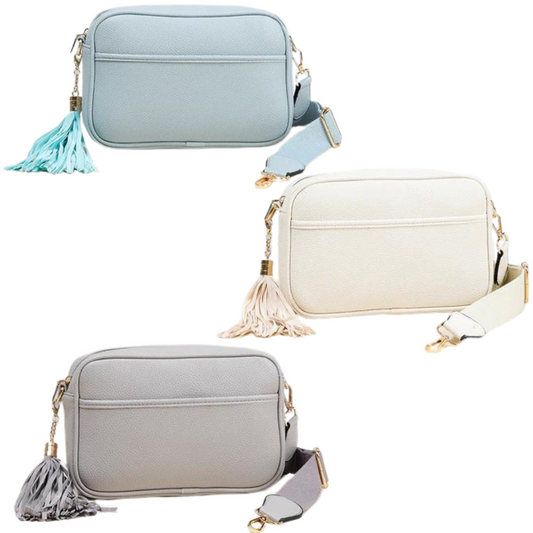 Stay stylish with the Tassel Camera Crossbody. Boasting a tassel accent and adjustable strap, this bag is available in four&nbsp;sophisticated colors: ivory, nude, light grey and light blue. Keep your belongings safe and secure while looking your best.