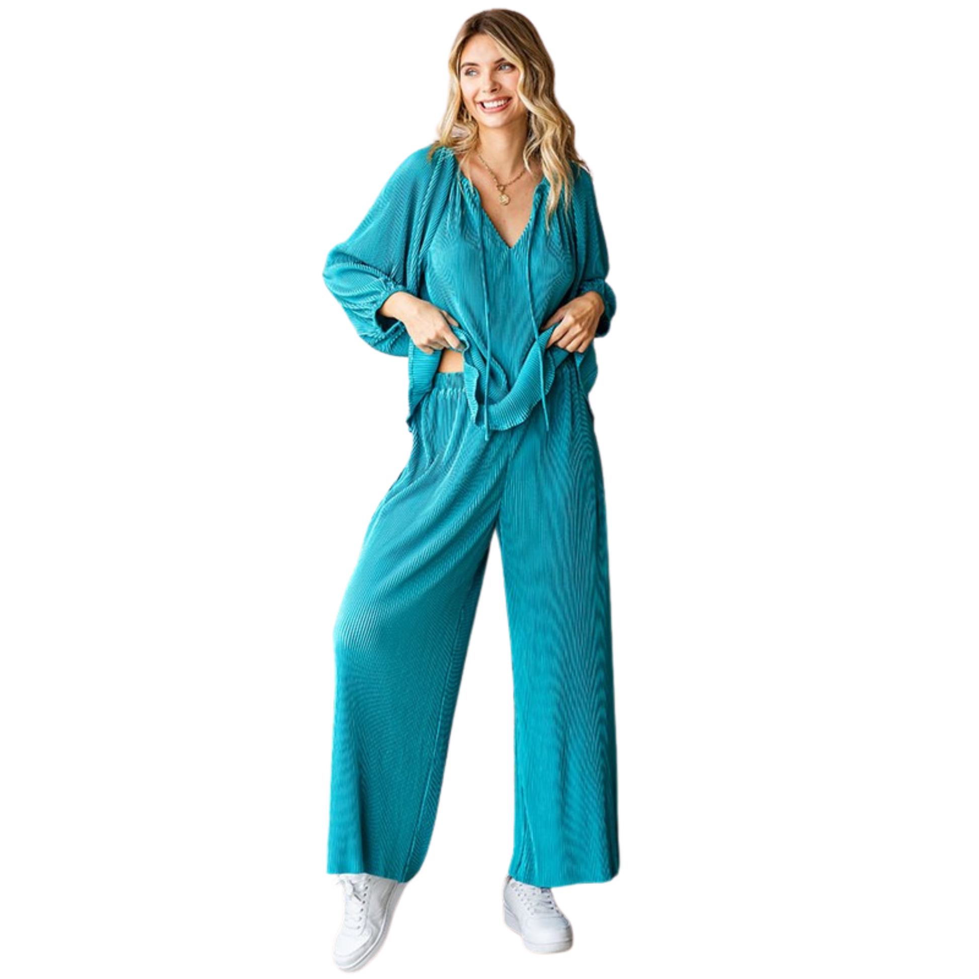 Effortlessly chic and comfortable, our Solid Color Pleated Top and Bottom Set is perfect for any occasion. The relaxed fit palazzo pants feature an elastic banded waistline for a flattering and comfortable fit. Paired with the matching top, this set is a must-have in your wardrobe. Available in a stunning teal color.