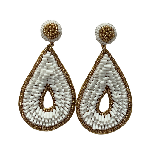 These Teardrop Beaded Earrings are crafted with white beads and lined with a gold bead. Its unique teardrop shape and dangle make them a perfect addition to any jewelry collection. From casual ensembles to elevated looks, these earrings are sure to add an eye-catching touch.