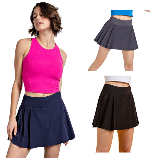 Experience maximum movement and comfort with the Active Pleat Tennis Skort. Crafted from a stretch woven material with pleats and a waistband, this 2-in-1 skort looks great while providing unrestricted movement on the court. Available in black, charcoal, or navy.