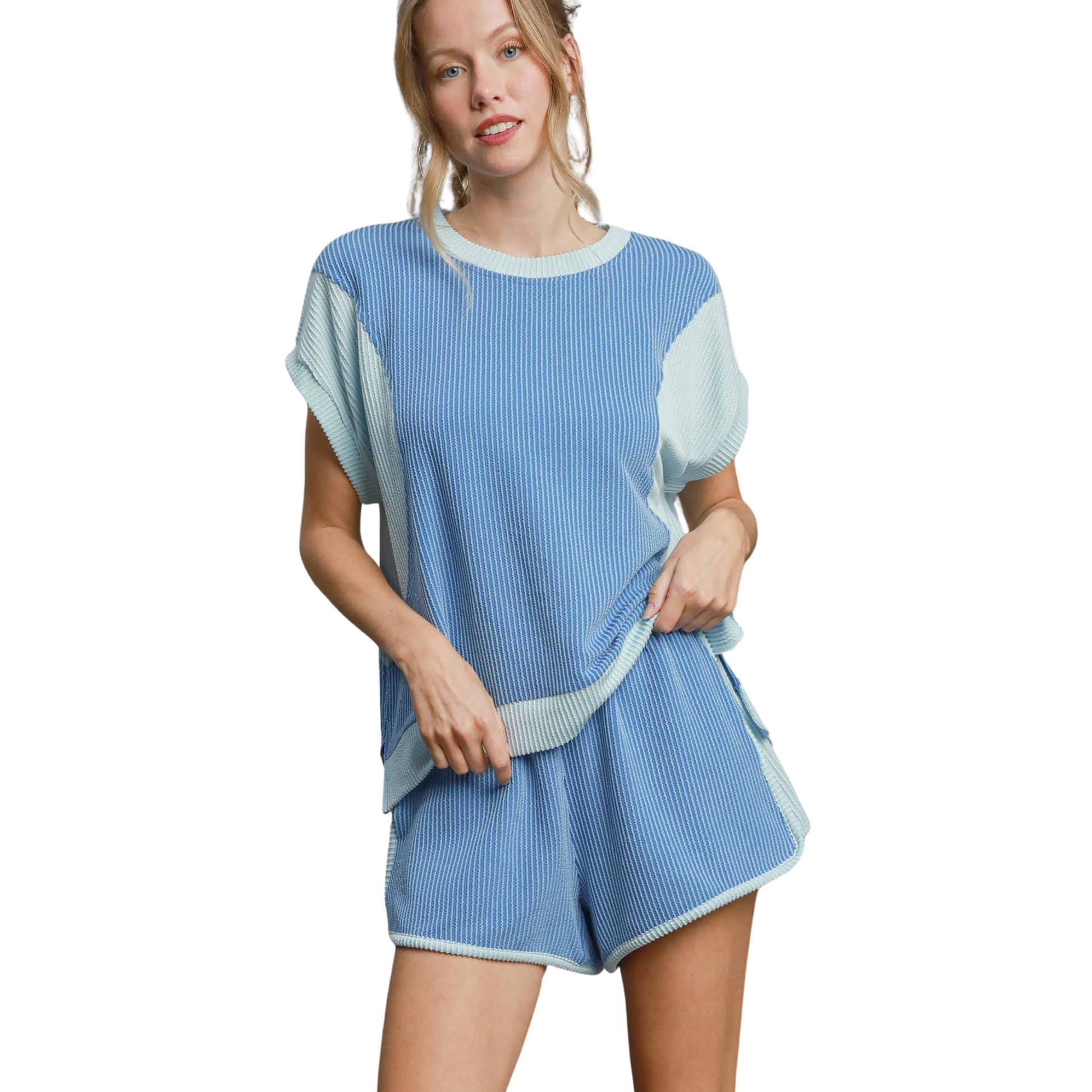 This Umgee brand set features a sky blue color and a textured design, perfect for adding a touch of uniqueness to any outfit. The short-sleeved top and shorts offer a comfortable and stylish fit, making it an ideal addition to your wardrobe. Elevate your style with this Textured Color Block Top and Shorts Set.