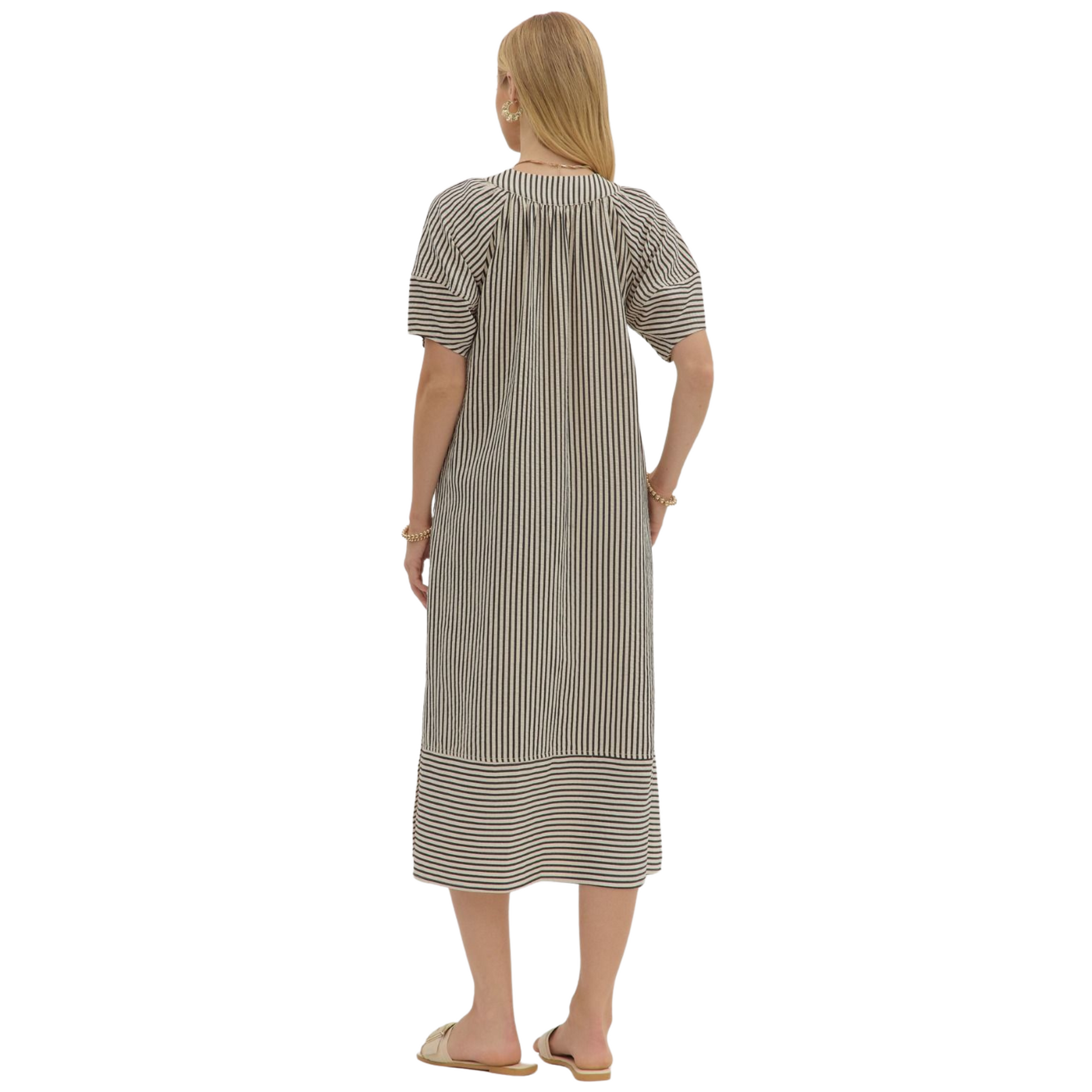 Embrace autumn elegance with the Entro black striped V-neck midi dress. Crafted for fall, its textured fabric offers subtle depth and warmth, while the flattering V-neckline and midi length provide a sophisticated silhouette. Perfect for layering or wearing alone, this dress balances comfort and style for the seasonal transition.
