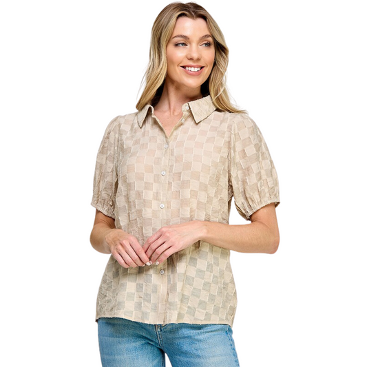 This Textured Short Sleeved Top is made of a cream-colored, textured cotton fabric, featuring a collared neckline with button up closure. Perfect for any occasion, this timeless piece offers a classic look with a touch of modern texture.
