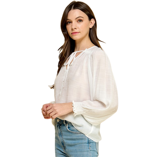Stay cool in the summer heat with this lightweight Tied Neck Long Sleeve Top. The sheer, white color will keep you looking polished in the sun while the tie top ensures a flattering fit. Enjoy the lightweight material for a comfortable look all season.