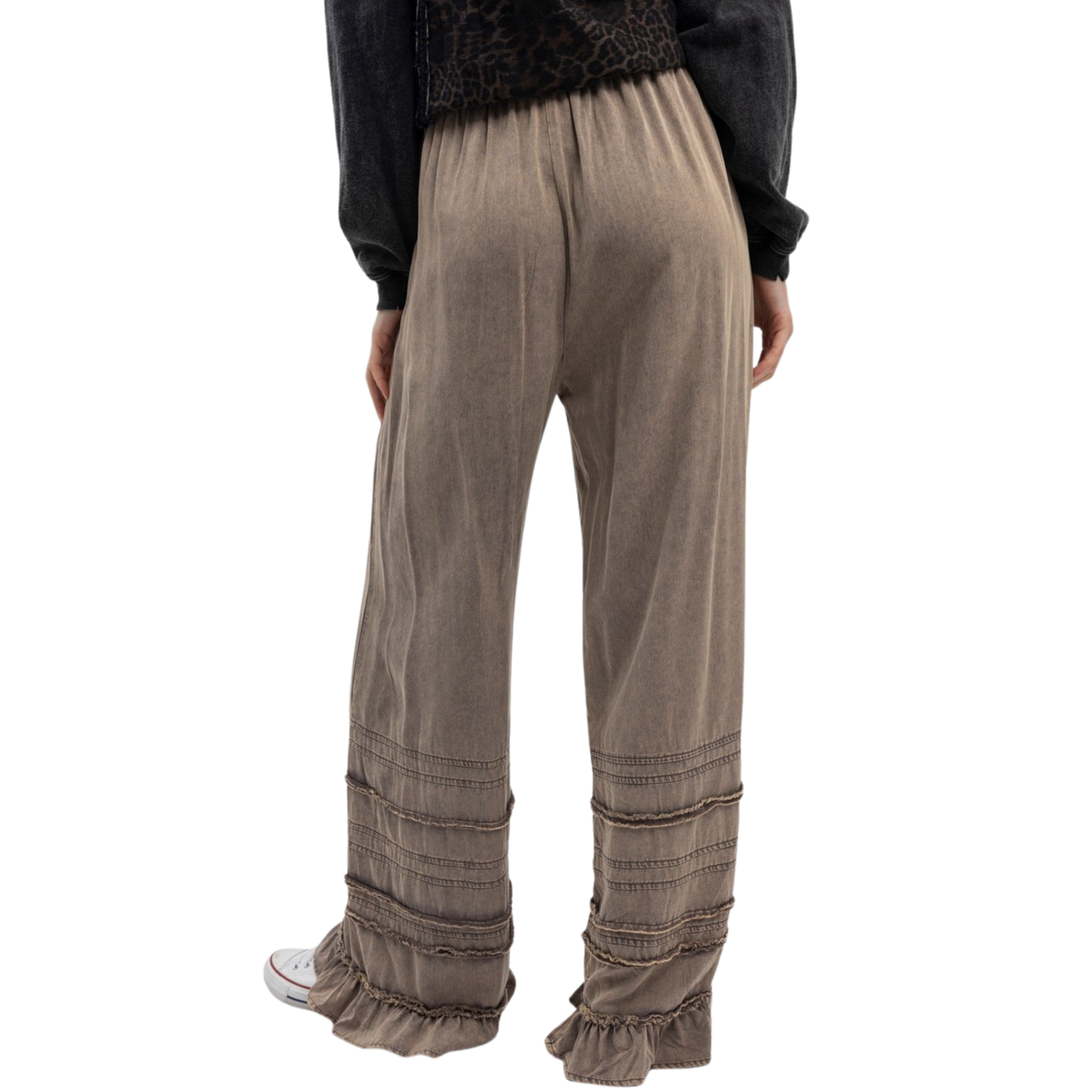 Effortless elegance meets comfort in these Tiered Pull On Wide Leg Pants by Blue Velvet. Crafted in a sophisticated charcoal color, these pants feature a relaxed wide-leg silhouette that flatters every frame. The elastic waist ensures all-day comfort without sacrificing style, while delicate ruffled tiers add movement and visual interest to the legs. Perfect for casual outings or dressed-up occasions, these versatile pants transition seamlessly from day to night. 
