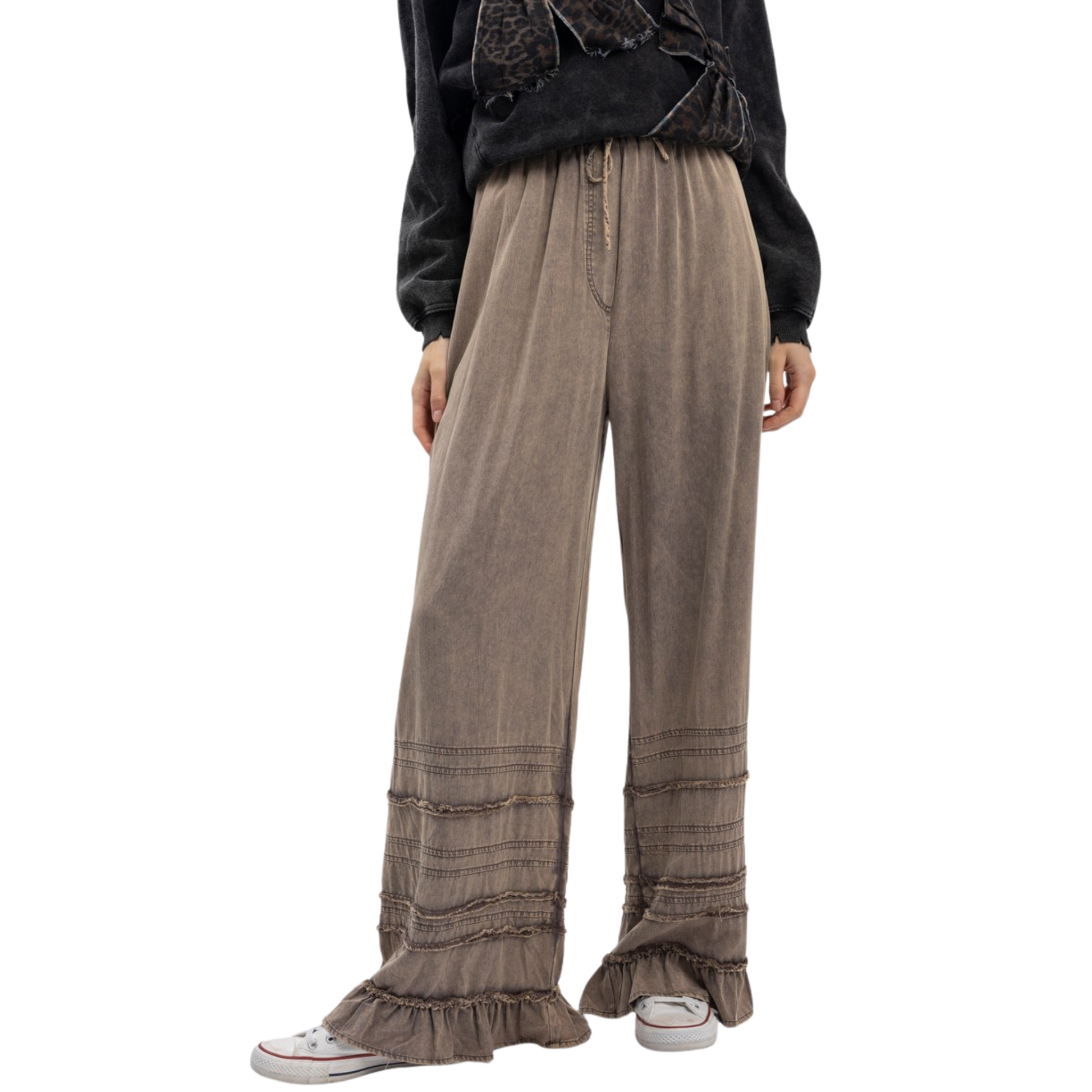 Effortless elegance meets comfort in these Tiered Pull On Wide Leg Pants by Blue Velvet. Crafted in a sophisticated charcoal color, these pants feature a relaxed wide-leg silhouette that flatters every frame. The elastic waist ensures all-day comfort without sacrificing style, while delicate ruffled tiers add movement and visual interest to the legs. Perfect for casual outings or dressed-up occasions, these versatile pants transition seamlessly from day to night. 