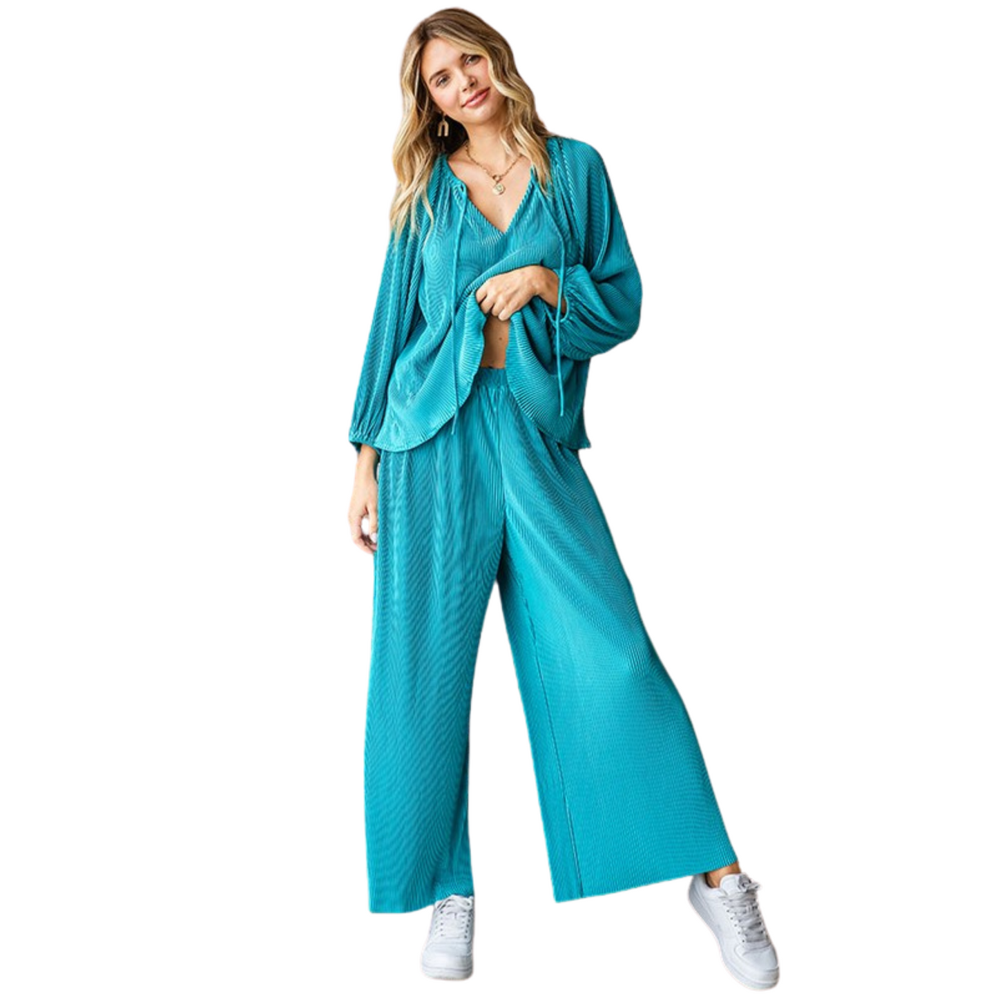 Effortlessly chic and comfortable, our Solid Color Pleated Top and Bottom Set is perfect for any occasion. The relaxed fit palazzo pants feature an elastic banded waistline for a flattering and comfortable fit. Paired with the matching top, this set is a must-have in your wardrobe. Available in a stunning teal color.