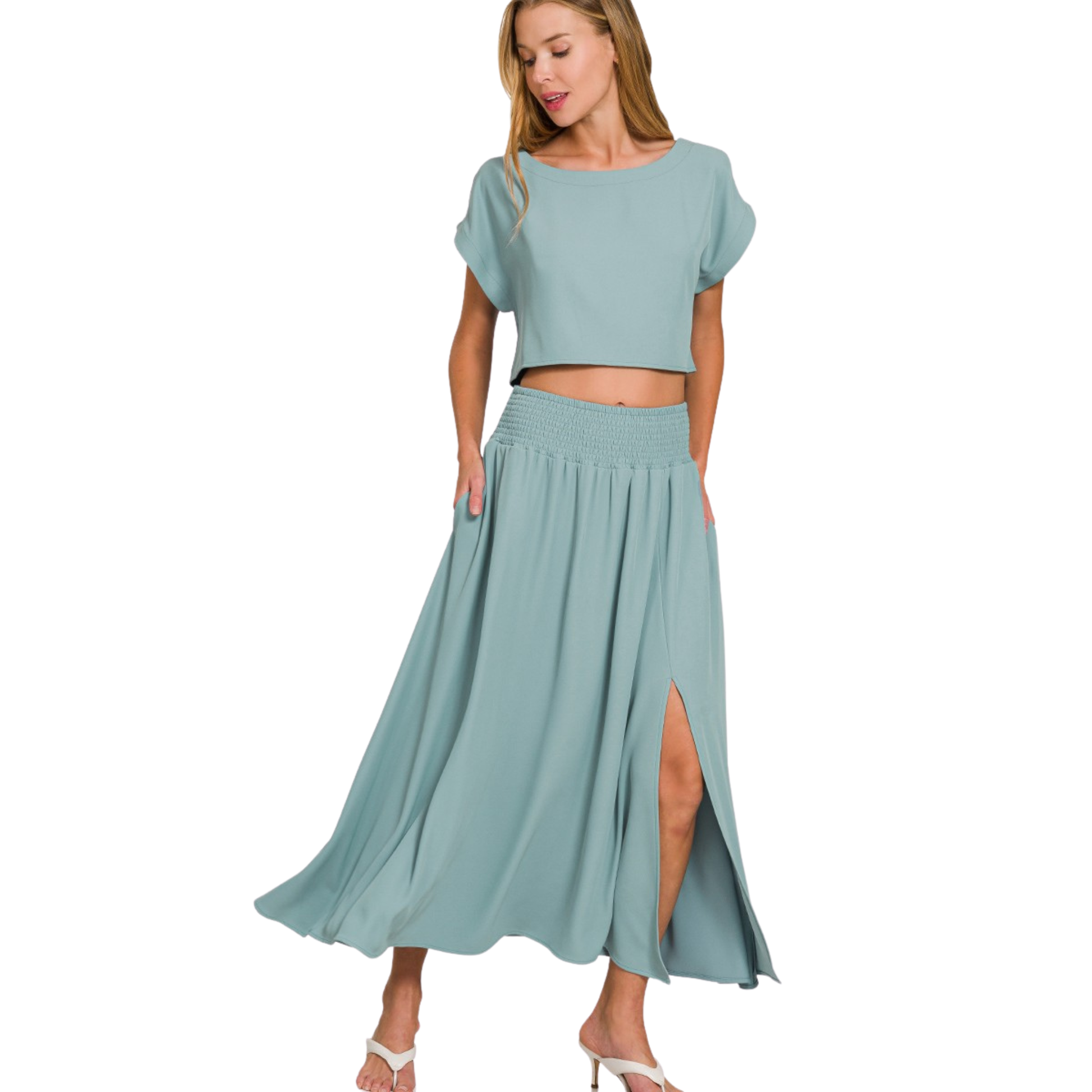 Elevate your casual wardrobe with this versatile Zenana set featuring a blue-grey cropped tee paired with a flowing maxi skirt. The short-sleeve tee offers effortless comfort, while the maxi skirt's strategic slit provides movement and modern appeal. This combination strikes the perfect balance between relaxed and refined, making it ideal for layering or wearing as a complete look. The coordinated color palette ensures seamless styling, whether you're dressing down for everyday wear or elevating the set for