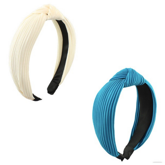 The Top Knot Headband will keep your hair in place without compromising on style. Crafted with fabric wrap, the headband is available in two colors: teal and ivory. You'll stay comfortable and chic all day long.