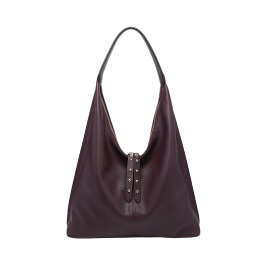 The Tori Slouchy Hobo Bag by Jen &amp; Co. combines a rich dark purple hue with a relaxed silhouette, offering both style and practicality. Its spacious interior accommodates daily essentials effortlessly, while the distinctive tassel accent adds a refined touch. Crafted for those who appreciate expert design, this bag balances casual elegance with functional appeal.