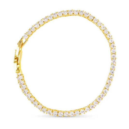 Elevate your jewelry collection with this Traditional Tennis Bracelet by Amanda Blu. Crafted in gleaming gold, it features a delicate line of sparkling rhinestone accents that catch the light with every movement. This classic design offers both timeless elegance and versatile wearability, making it an expert choice for adding refined sparkle to any outfit.