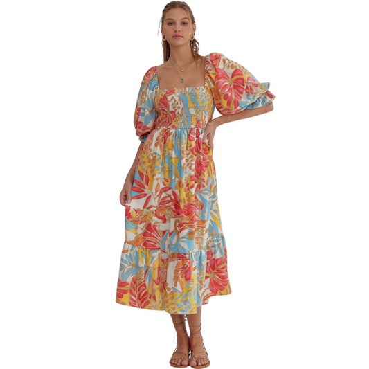 Add some color to your wardrobe with our Tropical Print Midi Dress. Featuring a square neck and half sleeves, this midi dress is perfect for any occasion. The smocking detail at the back ensures a comfortable and flattering fit. With elasticized sleeves and a lightweight, non-sheer fabric, you'll look and feel great all day long.